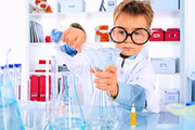Cute boy is making science experiments in a laboratory. Education.