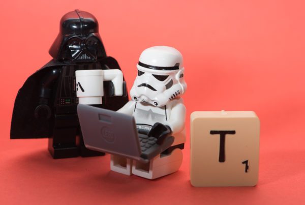 Lego Star Wars scene with Drone using a laptop and a T scrabble tile