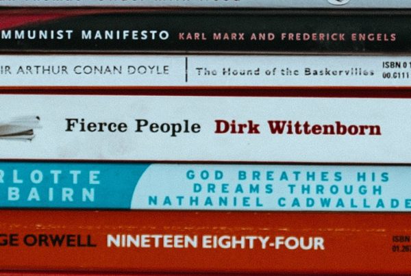 many books on their side with the spine facing forward
